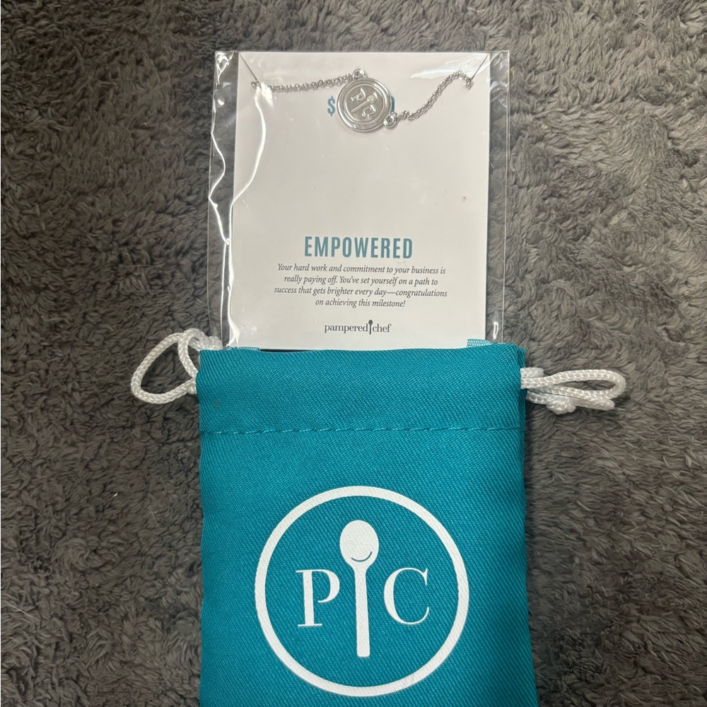 Pampered Chef Silver 'Empowered' Pendant Necklace with Teal Pouch